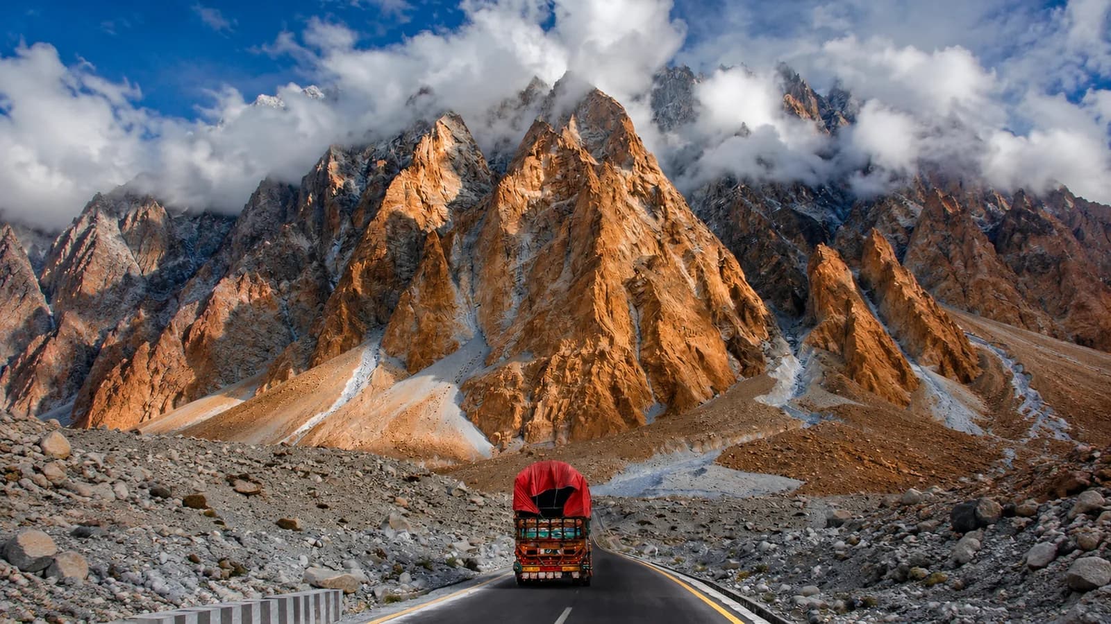 A decorated truck on the Karakoram Highway beneath the Passu Cones
